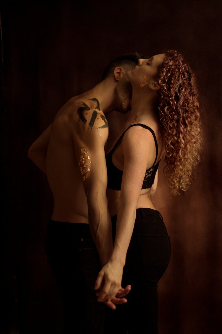 man kissing his girlfriend's neck in a photo studio in orlando