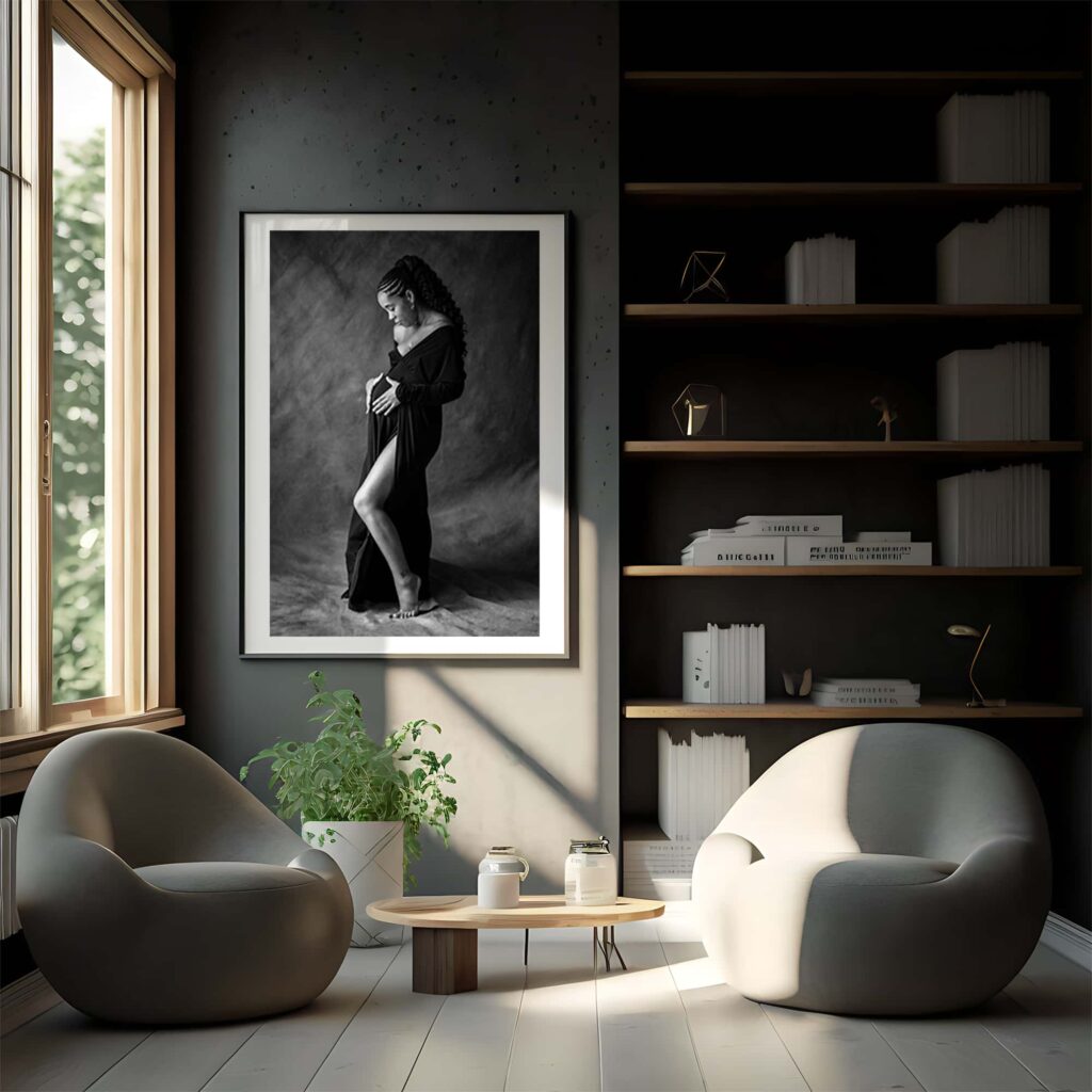 wall with books and framed print of a young pregnant woman wearing a black dress