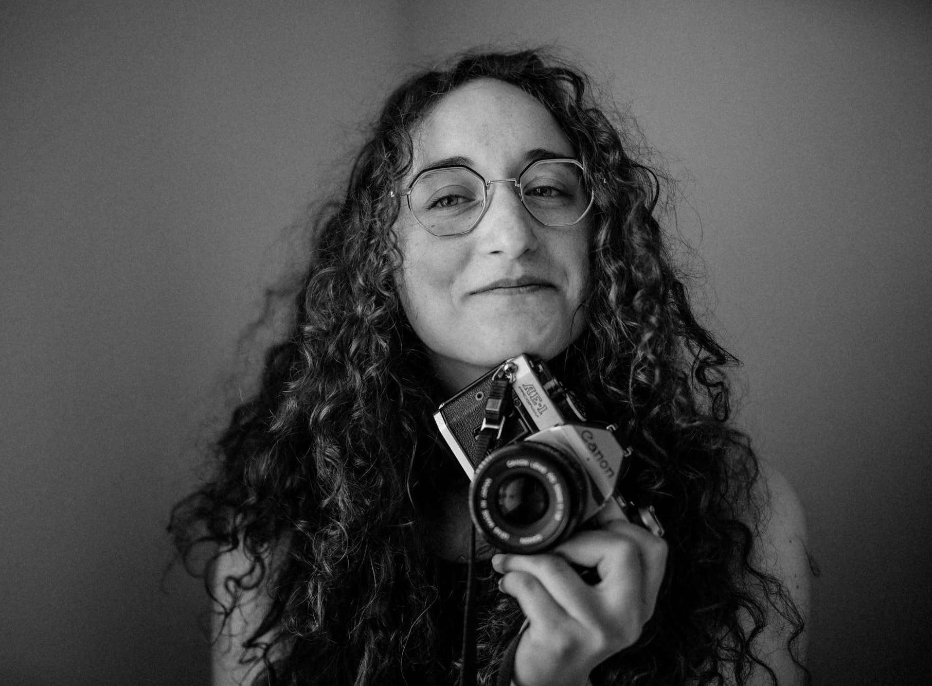 Kelly Abramson smiling holding a camera